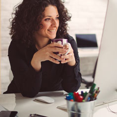 Woman enjoying a cup of coffee at work