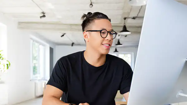 Graphic designers sits in front of computer