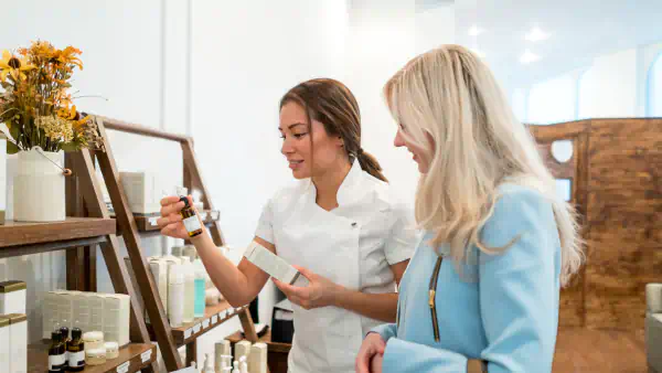 Spa worker shows wares to a customer